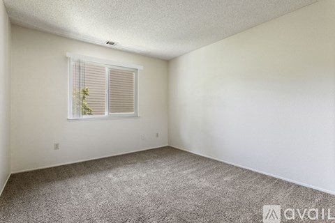 A bedroom with a large bed and a wooden headboard.