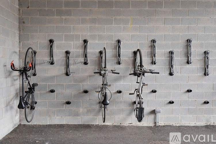 A wall of bike racks with bikes parked on them.