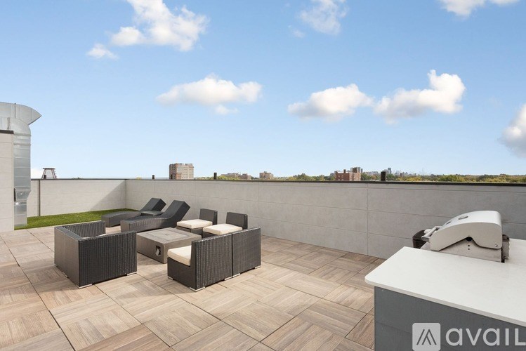 A patio with a white table and chairs overlooking a city skyline.