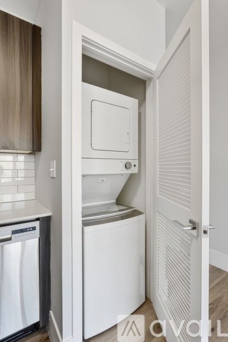 A small laundry room with a washer and dryer.
