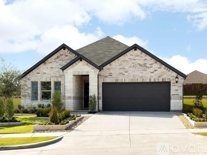 A modern house with a grey garage door and a black roof.