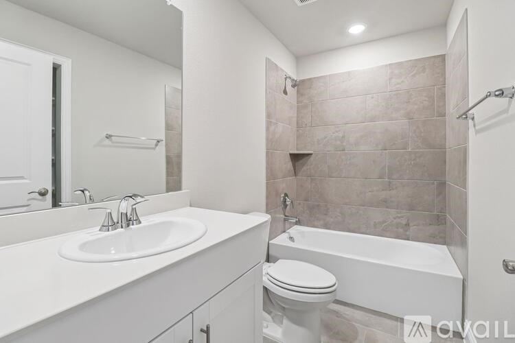 A bathroom with a white sink and toilet.