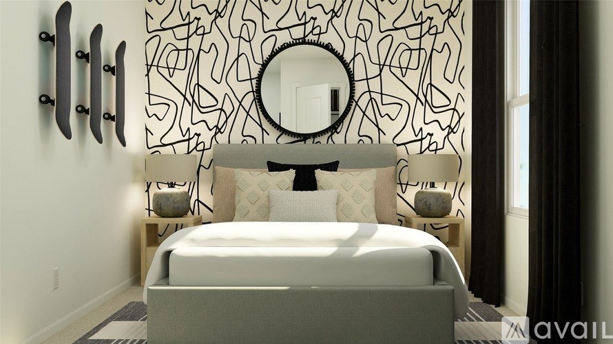 A bedroom with a white bed and a black and white patterned wallpaper.