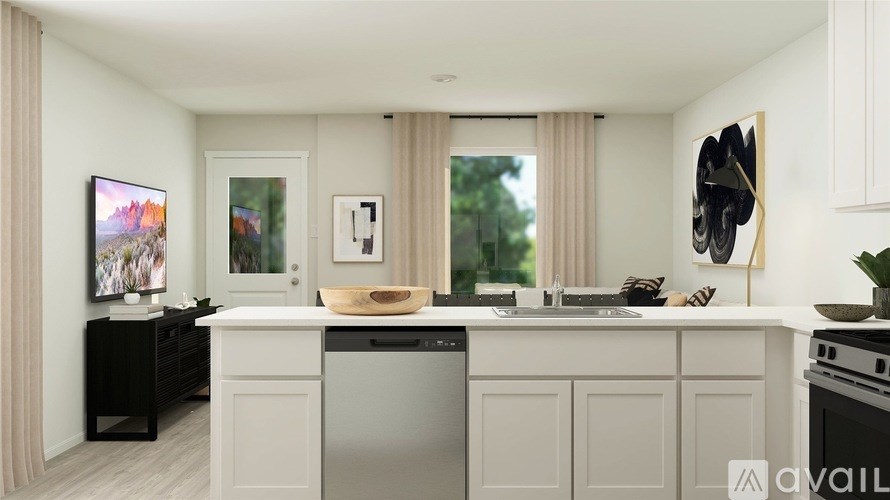 A modern kitchen with a large island and a dishwasher.