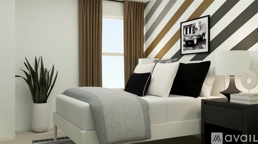 A bedroom with a white bed and a striped wallpaper.