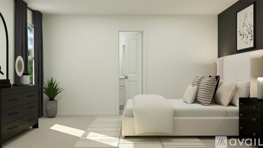 A modern bedroom with a large bed and a plant.