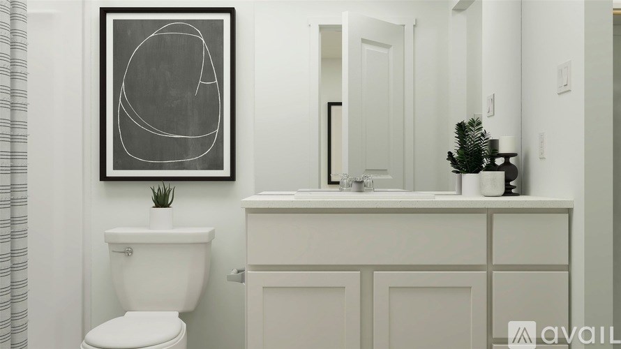 A white toilet sits next to a white sink in a bathroom.