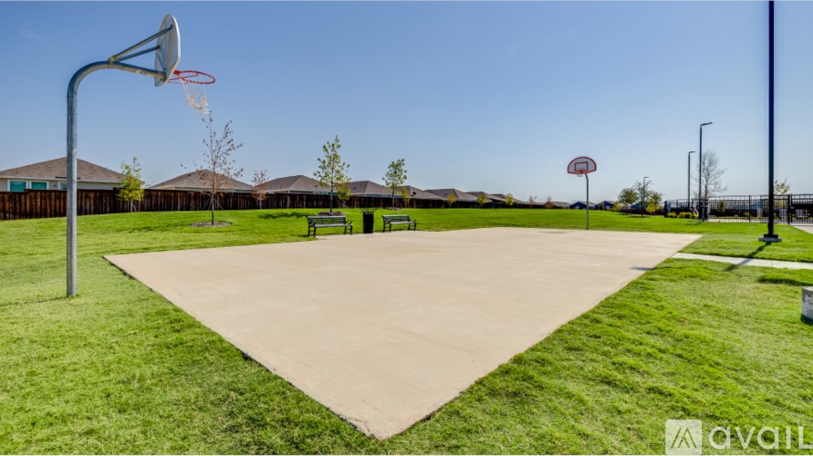 A basketball court with a hoop and a sign that says "AVAIL".