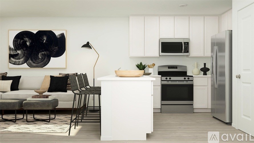 A modern kitchen with white cabinets and stainless steel appliances.