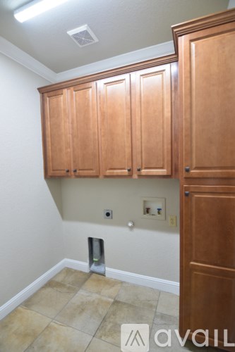A room with wooden cabinets and a tiled floor.
