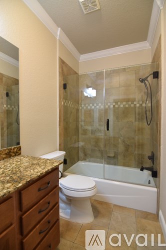 A bathroom with a toilet, sink, and shower.