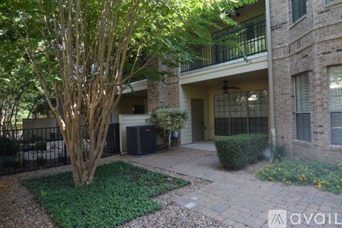 A tree in a yard in front of a house.