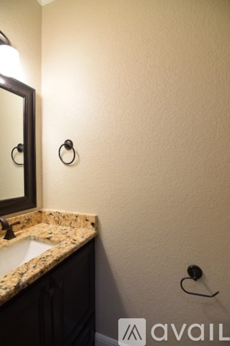 A bathroom with a sink and a mirror.