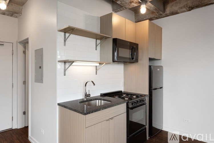 A kitchen with a black countertop and a black stove top oven.
