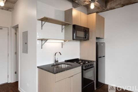 A kitchen with a black countertop and a black stove top oven.