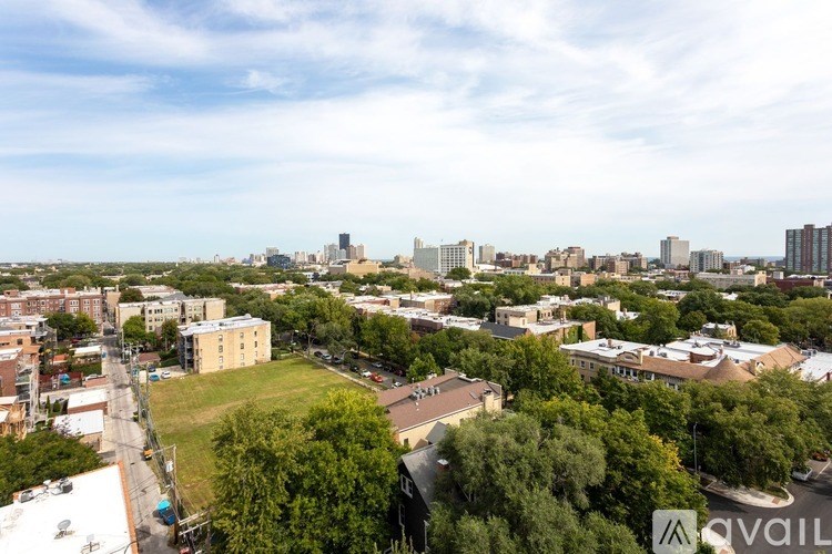 A cityscape with buildings and trees in the foreground.