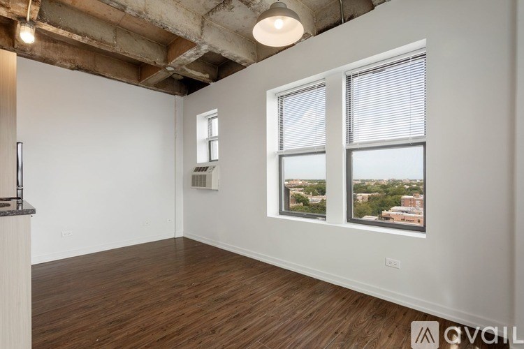 A room with a window showing a view of a cityscape.