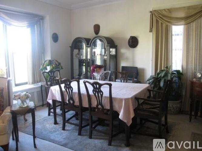 A dining room with a table set for six.