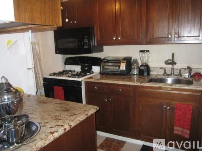 A kitchen with a black microwave above the stove.