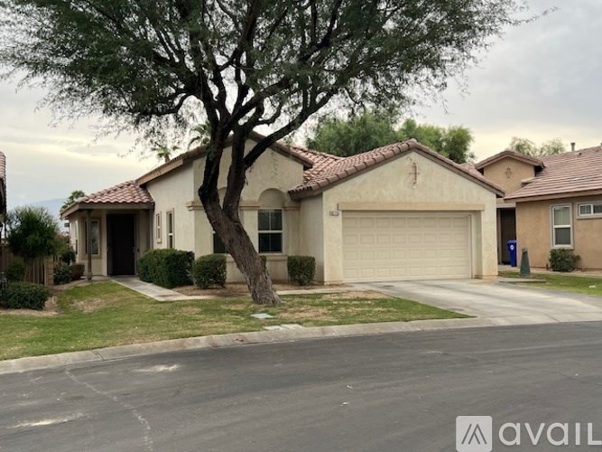 A house with a tree in front of it.