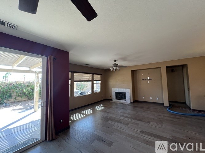 A room with a ceiling fan and a fireplace is available for rent.