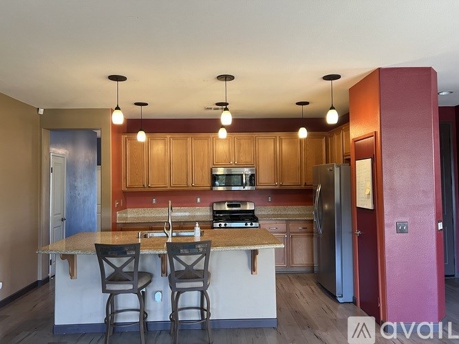 A kitchen with wooden cabinets and a granite countertop.