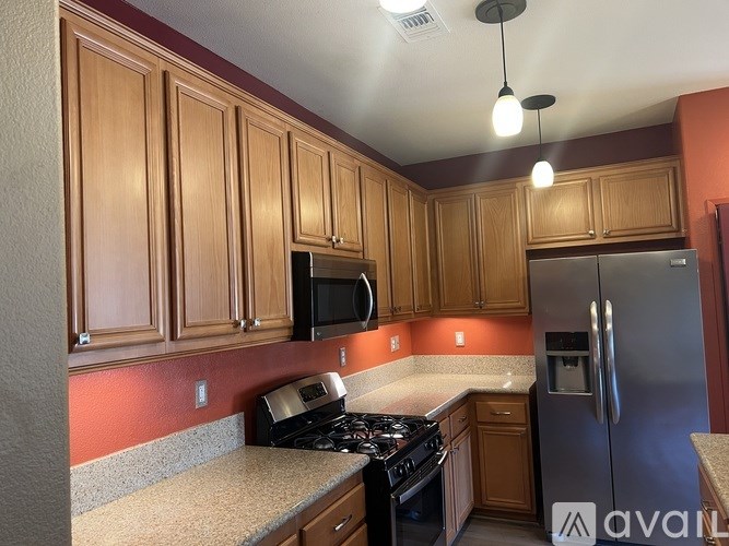 A kitchen with wooden cabinets and stainless steel appliances.
