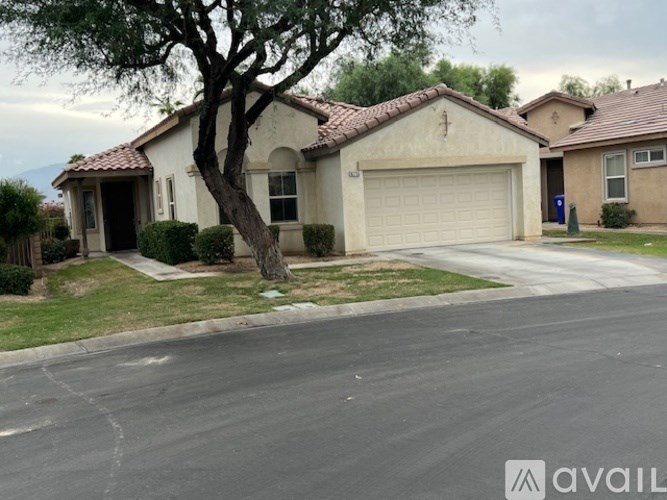 A house with a tree in front of it.