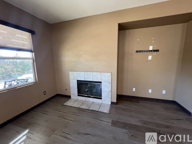 A living room with a fireplace and a window.