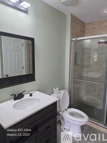 A bathroom with a white toilet and a white sink.