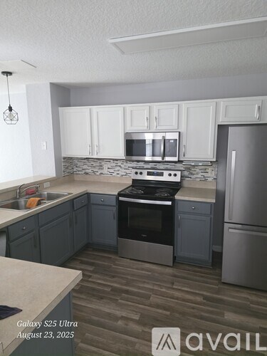 A kitchen with a stove top oven and a refrigerator.