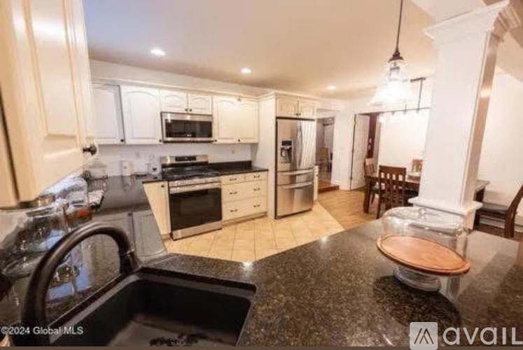 A kitchen with granite countertops and stainless steel appliances.