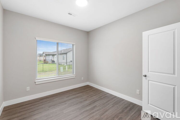 A room with a window and a door.