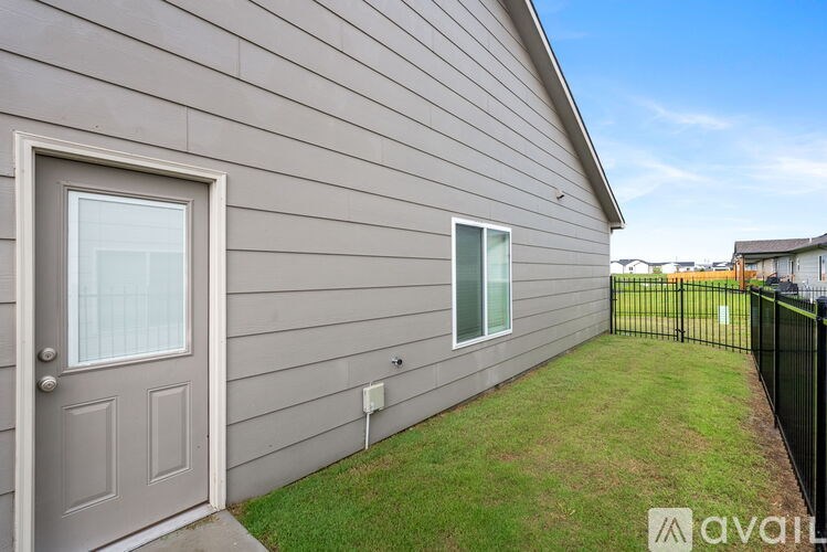 A house with a grey door and a window is for sale.