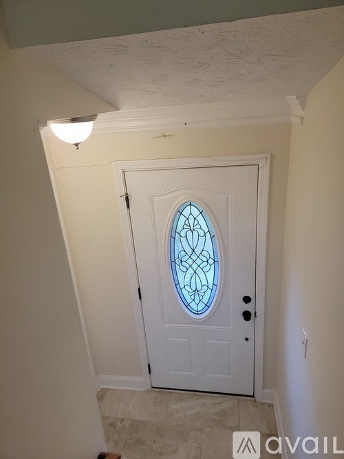A white door with a glass window in the middle.
