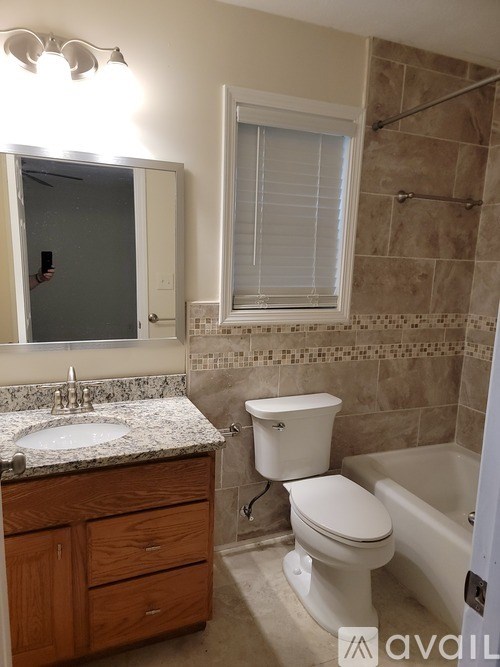A bathroom with a sink, toilet, and bathtub.