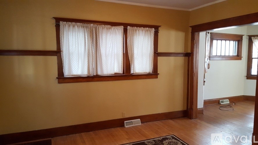 A room with a window and a door.