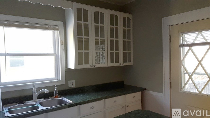 A kitchen with a sink and cabinets.