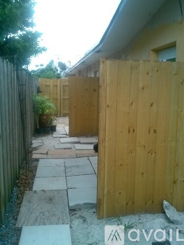 A wooden fence and gate in a yard.