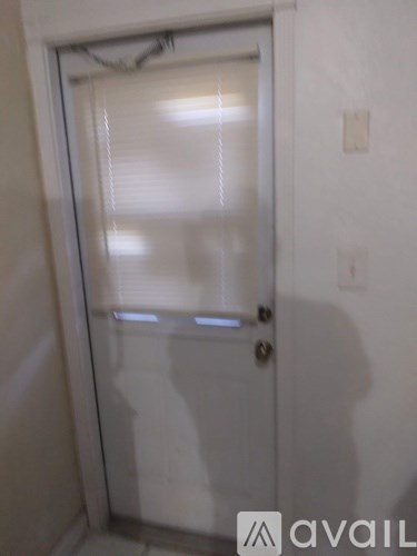 A white door with a window and a handle.