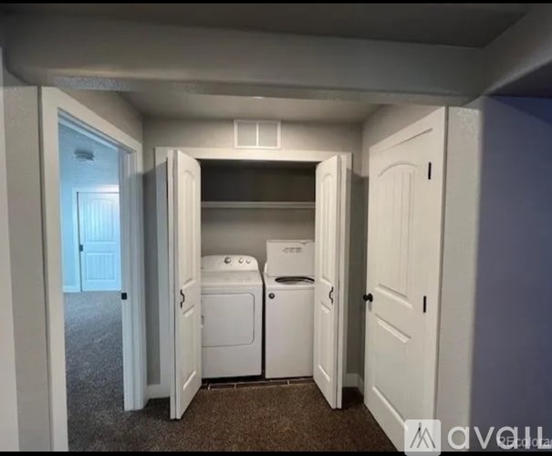 A small laundry room with a washer and dryer.