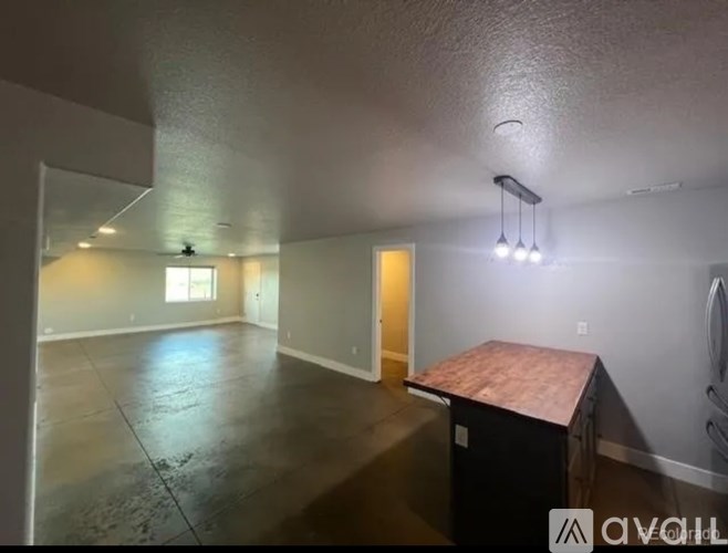 A room with a concrete floor and a ceiling fan.