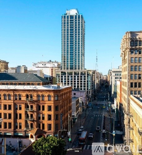 A city street with a tall building in the background.