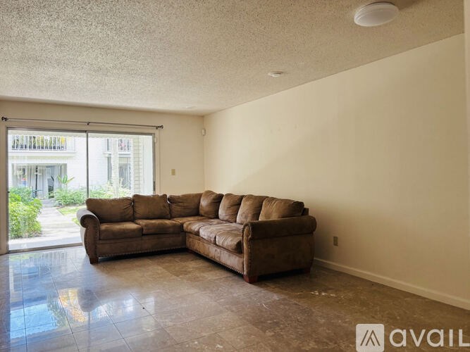 A living room with a couch and a cushion on it.