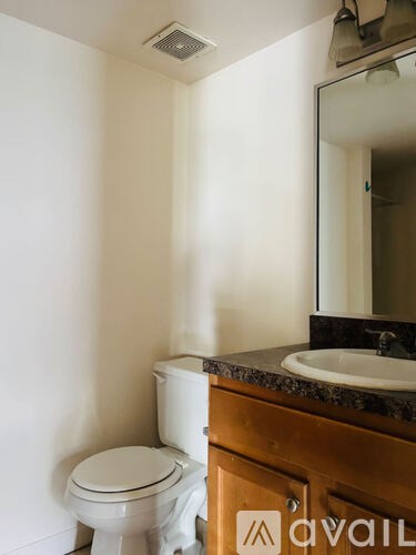 A white toilet sits next to a sink in a bathroom.