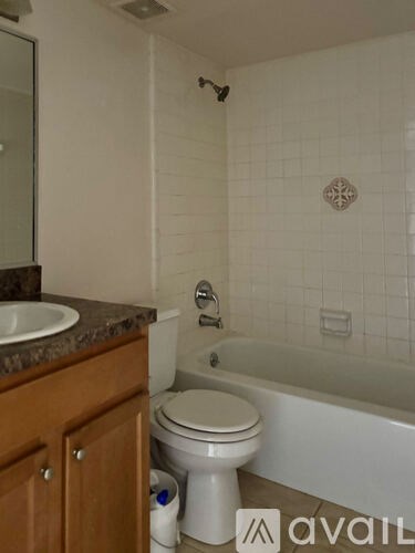 A bathroom with a toilet, sink, and bathtub.