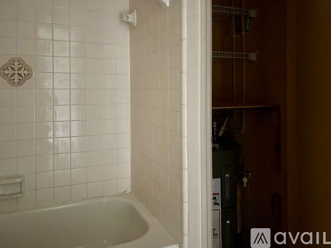 A bathroom with a white tiled shower and a bathtub.