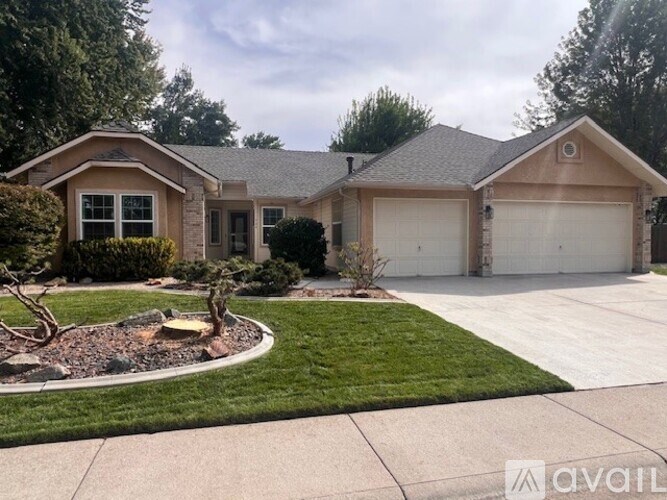 A house with a brown roof and a white garage door.