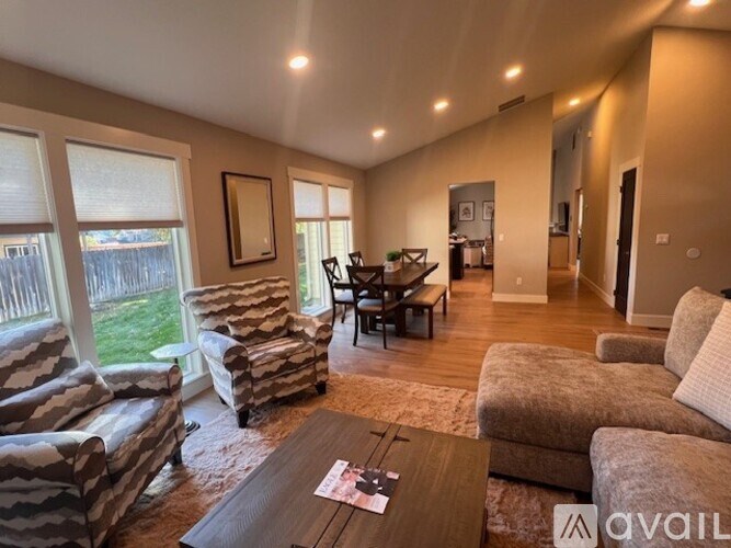 A living room with a couch, chair, and coffee table.