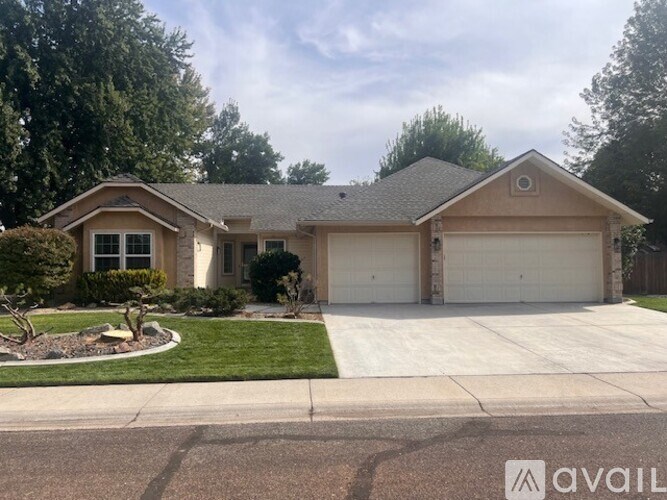 A house with a brown roof and a white garage door.